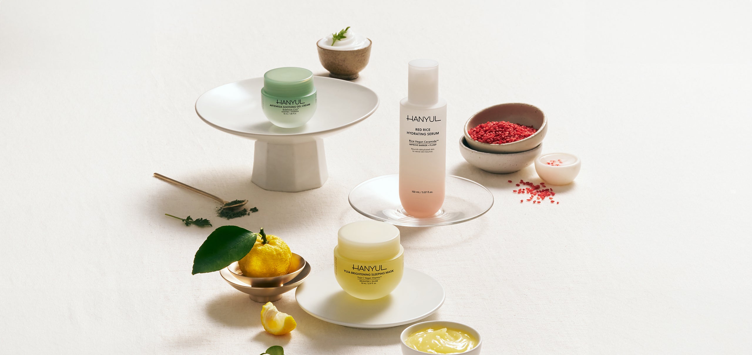 HANYUL Yuja, Artemisia, and Red Rice skincare products displayed elegantly with natural ingredients.